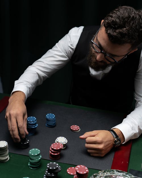 poker chips and coins on computer keyboard